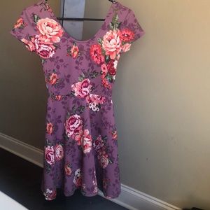 a purple dress with a multi color flower print